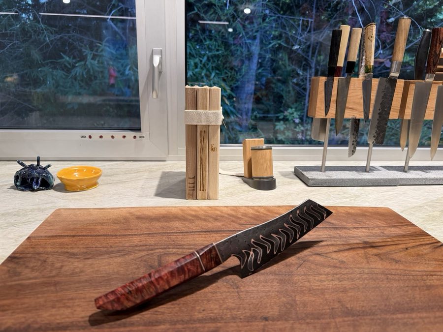 Martin, knife No. 002, on a walnut board in evening light